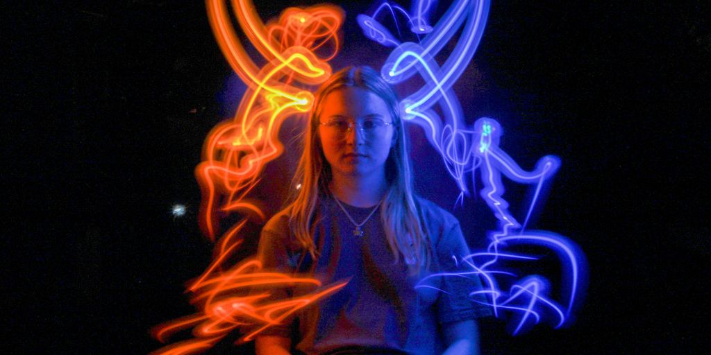 woman surrounded by blue and orange lights